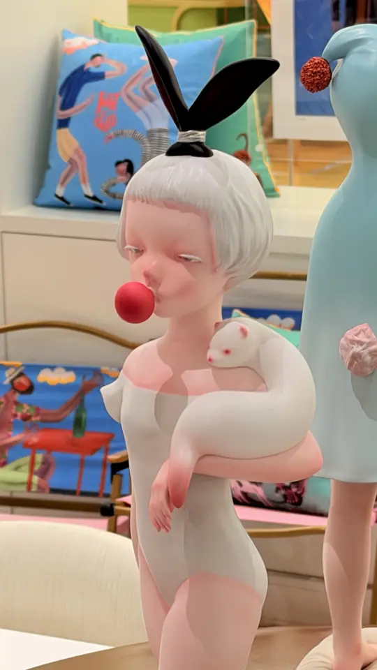A designer art toy of a girl holding a cat