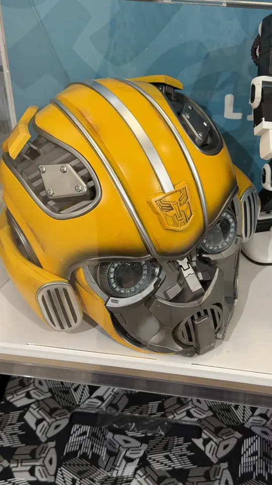 A yellow Transformers helmet on a shelf