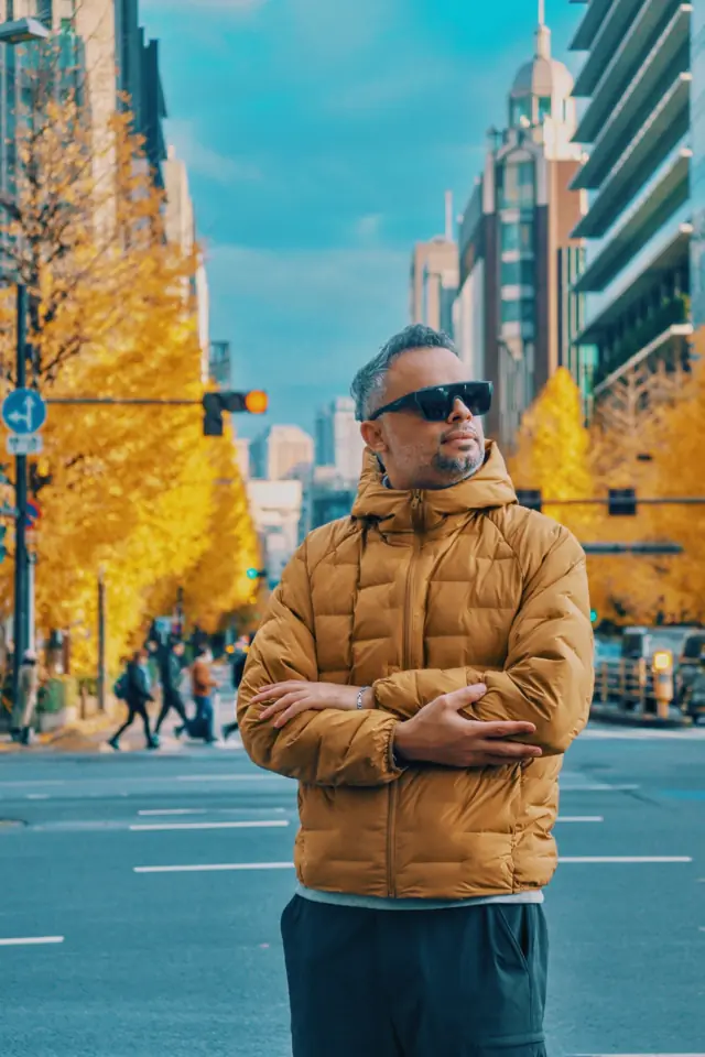 A portrait on a street lined with yellow ginkgo