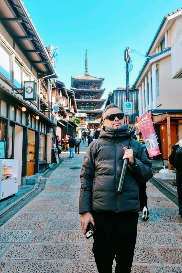 A portrait on a Kyoto street with a pagoda behind