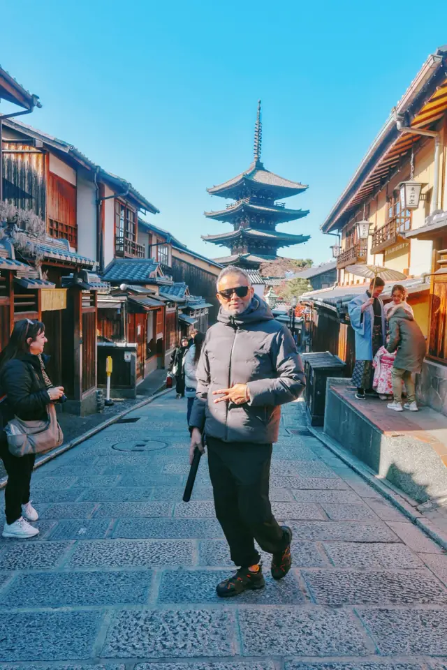 Walking up a street toward a pagoda