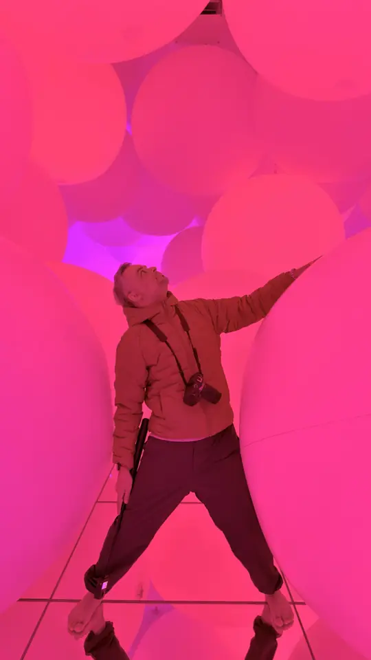 Standing in a glowing pink room