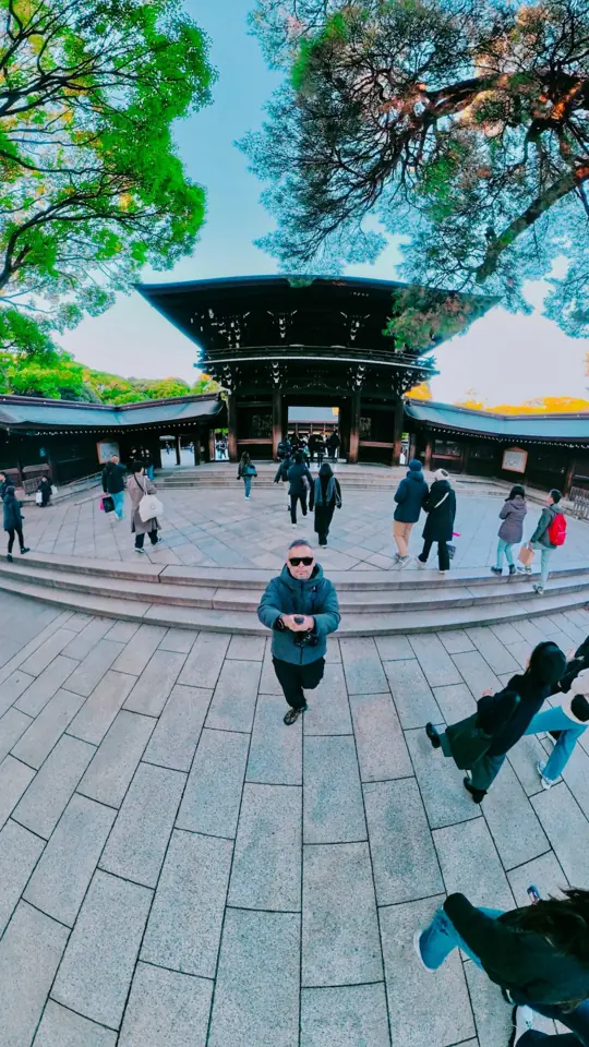 A wide-angle selfie before a shrine gate